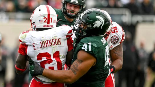 Michigan State Spartans defensive lineman Derrick Harmon tackles Nebraska running back Emmett Johnson Michigan State Spartans defensive lineman Derrick Harmon tackles Nebraska running back Emmett Johnson
