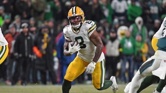 Green Bay Packers running back Josh Jacobs runs with the football during the 2024 NFL Playoffs.