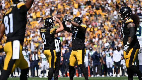 Aaron Rodgers and Broderick Jones celebrate after a touchdown against the Seattle Seahawks.