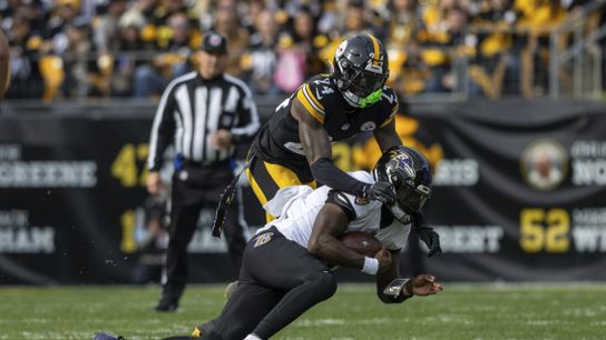 Steelers corner Joey Porter Jr. tackles Ravens quarterback Lamar Jackson during a game.