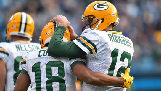Steelers' Aaron Rodgers with former Green Bay Packer teammate Randall Cobbs hugging on the sideline.